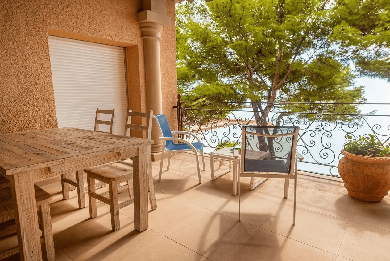 Terraza de madera y forja, a la sombra de los pinos